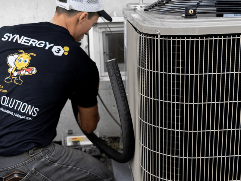 Synergy3 technician performing HVAC work